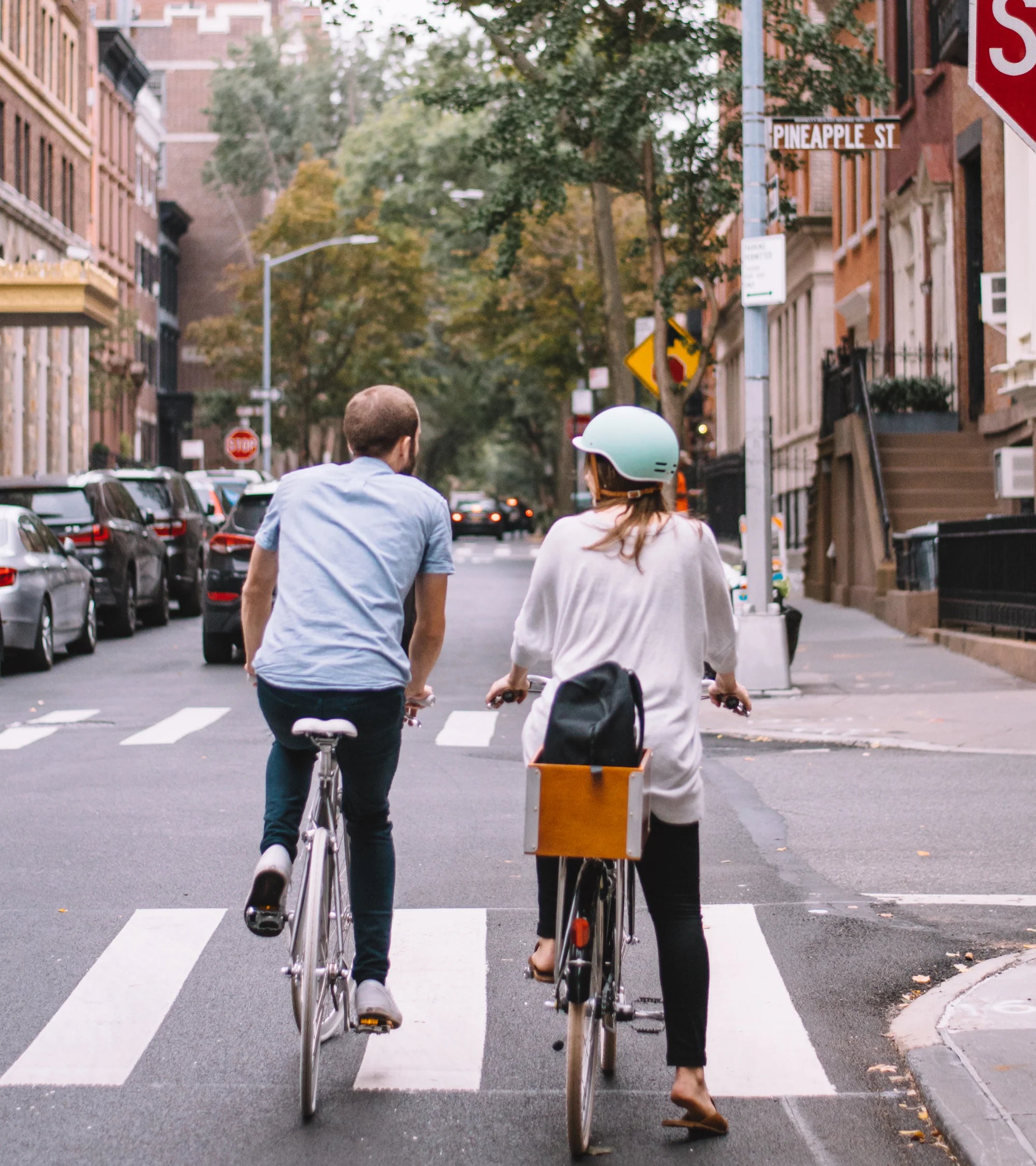 Two people side by ride riding their bikes